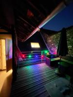 a room with colorful lights on the roof at night at L&#39;ENSOLEILLÉ - Classé 2 étoiles - Nay centre - Appartement in Nay