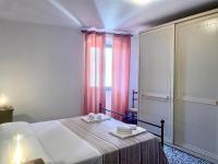 Posteľ alebo postele v izbe v ubytovaní Casa Vacanze La Casa di Nonna Libia vicino Saturnia