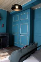 a blue room with a bed and a door at Eau Berges in Vicdessos