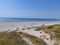 a group of people on a beach near the water at Granite stone house with fireplace, Plouguerneau in Plouguerneau