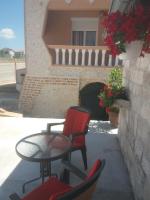 a patio with chairs and a table and a table and chairs at Apartments with a parking space Zadar - 15711 in Zadar