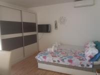 a bedroom with a bed and a tv on the wall at Apartments with a parking space Zadar - 15711 in Zadar