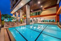 an indoor swimming pool in a building with a house at Bandara Suites Silom, Bangkok in Bangkok