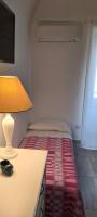 A bed or beds in a room at La Casetta di Meta