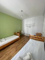 a bedroom with two bunk beds and a bathroom at Orange Cat Rooms in Riga