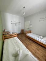 a bedroom with two beds in a room at Orange Cat Rooms in Riga