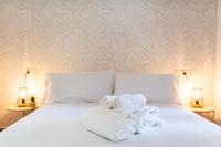 Łóżko lub łóżka w pokoju w obiekcie Home4u Casa del Tesoro I