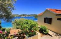 a house with a view of a body of water at Seaside holiday house Cove Gabrica, Korcula - 17195 in Vela Luka