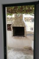 a stone fireplace is shown through a glass door at Seaside holiday house Cove Gabrica, Korcula - 17195 in Vela Luka