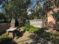 a stone fence and a bench in a garden at Apartments with a parking space Betina, Murter - 17478 in Betina