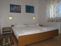 a bedroom with a large bed with white sheets at Apartments with a parking space Betina, Murter - 17478 in Betina