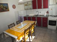 a kitchen with a table with chairs and a sink at Apartments with a parking space Betina, Murter - 17478 in Betina