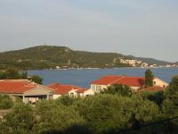 a group of houses and a body of water at Apartments with a parking space Betina, Murter - 17478 in Betina