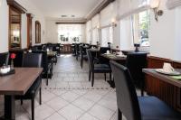 a dining room with tables and chairs in a restaurant at Hotel Jellentrup in Münster