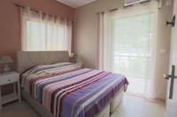 A bed or beds in a room at Vasileiou Apartments