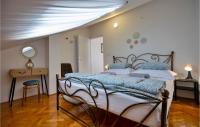 a bedroom with a bed and a table and a mirror at Cozy Apartment In Makarska With Wifi in Makarska