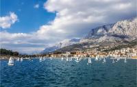 a group of sailboats on a body of water with mountains at Cozy Apartment In Makarska With Wifi in Makarska