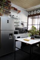 a kitchen with a refrigerator and a table in it at Eau Berges in Vicdessos