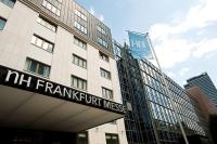 a building with a sign for the nhm frankfurtvent universes at NH Frankfurt Messe in Frankfurt