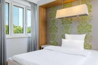 a bedroom with a bed and a window at NH Frankfurt Messe in Frankfurt