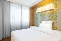 a bedroom with a white bed and a window at NH Frankfurt Messe in Frankfurt