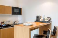 a kitchen with a counter with a sink and a microwave at NH Frankfurt Messe in Frankfurt