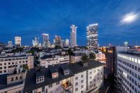 a city skyline at night with tall buildings at NH Frankfurt Messe in Frankfurt