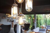 a group of lights hanging in a room with chairs at Orgánico Hotel Boutique in Mexico City