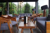a restaurant with chairs and tables and a large window at Orgánico Hotel Boutique in Mexico City