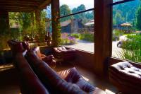 a living room with leather couches and a large window at Orgánico Hotel Boutique in Mexico City