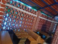 Habitación con pared de ladrillo, mesa y sillas. en RAJ RESORT & BANQUETS, en Vapi