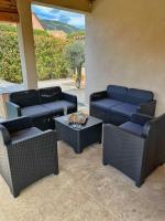 a patio with couches and a table and chairs at Villa avec piscine privée à Sainte Lucie in Sainte-Lucie de Porto-Vecchio