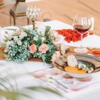 a table with a plate of food and a glass of wine at HARRIS Hotel Batam Center in Batam Center