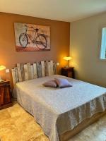 a bedroom with a bed with a bike on the wall at Villa avec piscine privée à Sainte Lucie in Sainte-Lucie de Porto-Vecchio