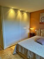 a bedroom with a bed and a lamp on a table at Villa avec piscine privée à Sainte Lucie in Sainte-Lucie de Porto-Vecchio