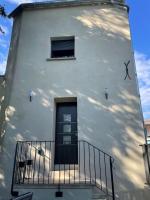 a white building with a window and a balcony at Meublé de tourisme 4 étoiles Logis Riquet proche de Carcassonne in Caux-et-Sauzens