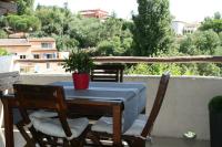 a table and chairs with a potted plant on a balcony at Coquet appartement dans mazet Ste Maxime (Riviera) classé 3 in Sainte-Maxime