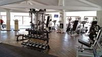 a gym with a bunch of equipment in a room at Camping Oasis Village in Puget-sur-Argens