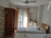 A bed or beds in a room at Hostal Burbia