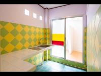 a colorful bathroom with a sink and a window at Gooddays Lanta Beach Resort SHA in Ko Lanta