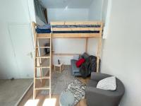 a small room with a bunk bed and a couch at LE PRESTRE in Besançon