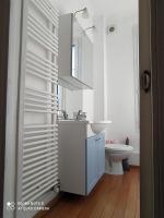 a white bathroom with a sink and a toilet at Maison de maître, un coin de verdure en hyper centre in Lisieux