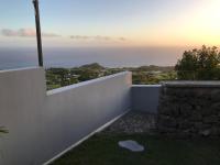 a view of the ocean from the balcony of a house at loft meublé fonctionnel proche de grande anse in Petite Île