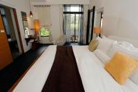 a large white bed sitting in a room at Mudanwan Villa in Mudan