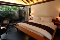 a bedroom with a large bed and a large window at Mudanwan Villa in Mudan