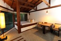 a room with a bed and a desk and a table at Mudanwan Villa in Mudan