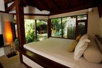 a bedroom with a bed with a large window at Mudanwan Villa in Mudan