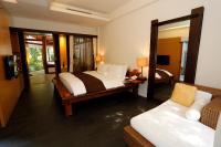 a bedroom with a bed and a mirror and a couch at Mudanwan Villa in Mudan