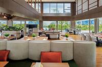 a restaurant with tables and chairs and large windows at PARKROYAL COLLECTION Marina Bay, Singapore in Singapore