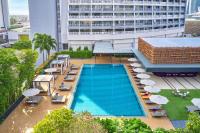 an overhead view of a swimming pool with chairs and umbrellas at PARKROYAL COLLECTION Marina Bay, Singapore in Singapore